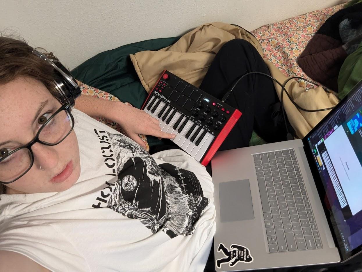 they/them grandson with a laptop and a midi keyboard